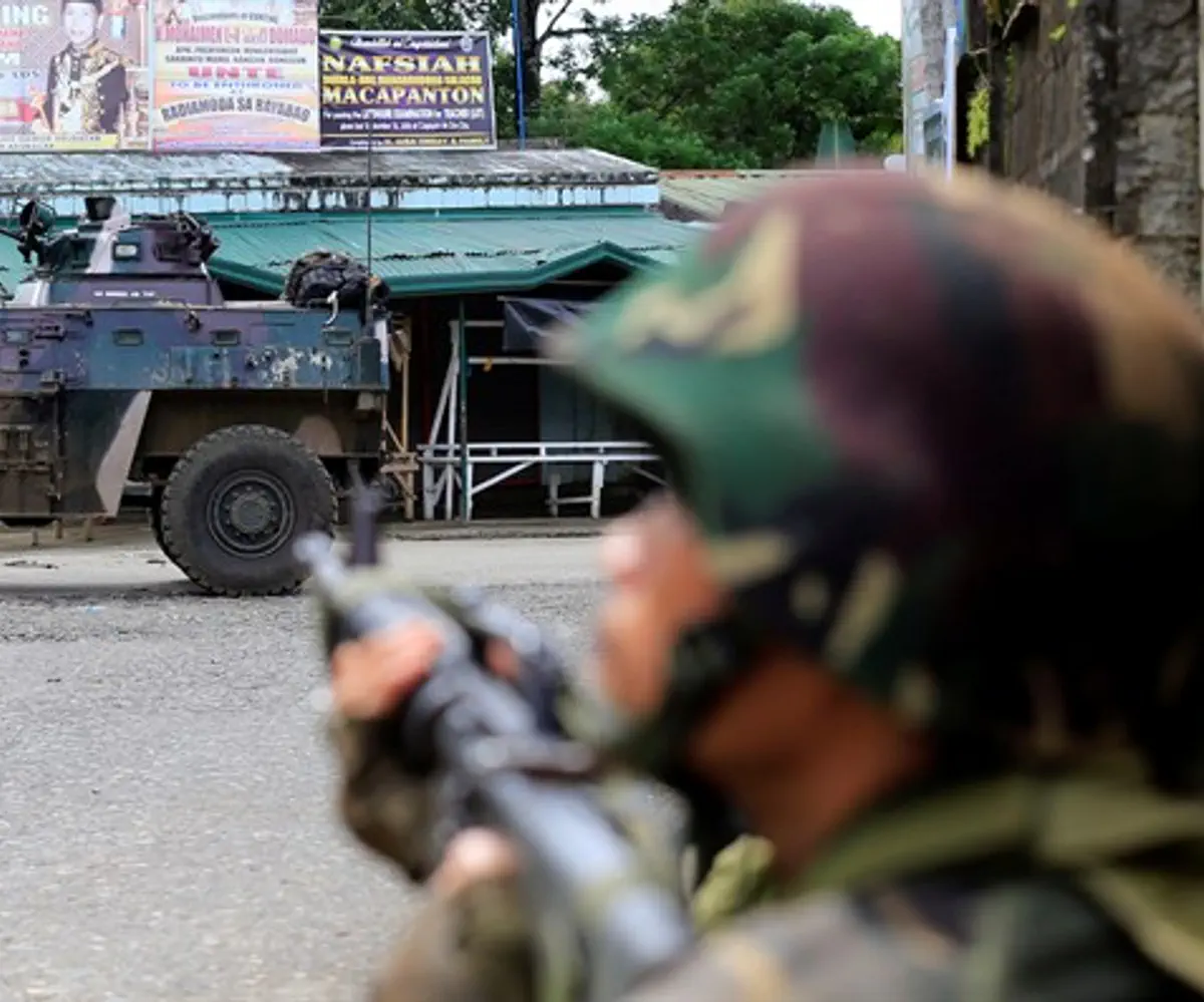 Government troops seen during assault by insurgents from the so-called Maute group
