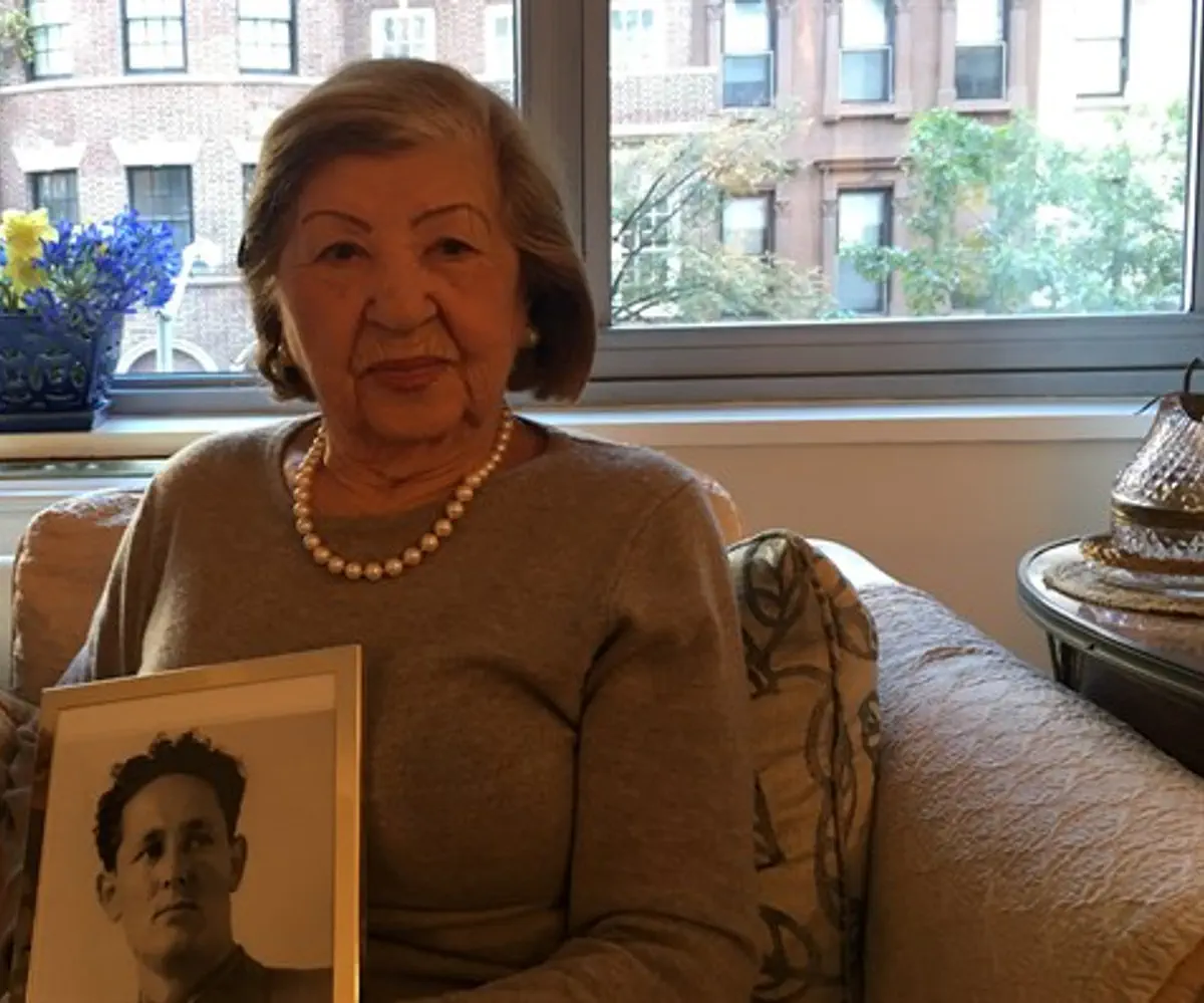 Rose Holm at her apartment holding a photo of her late husband, Joe