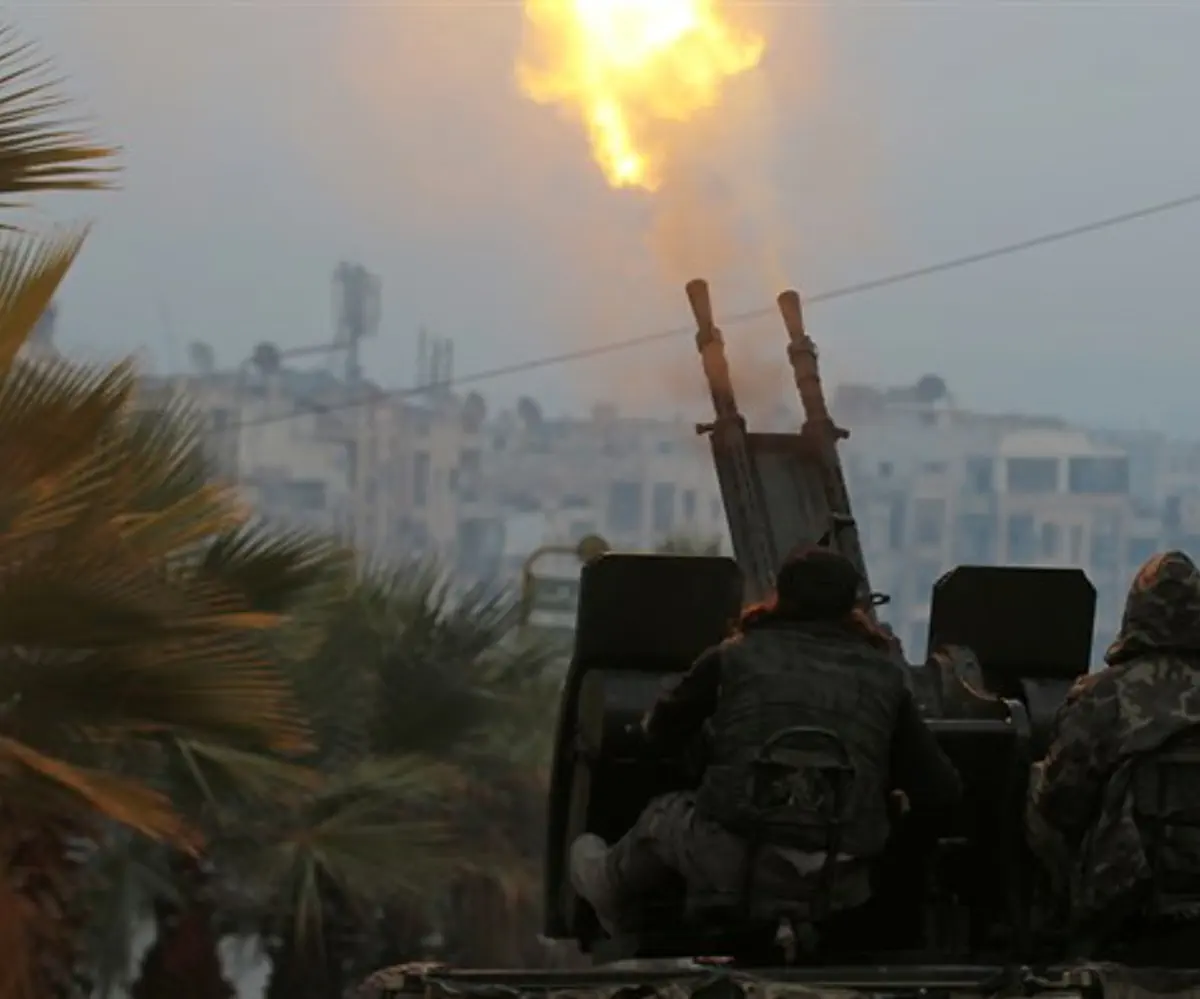 Anti-Assad rebel fighters fire anti-aircraft weapon