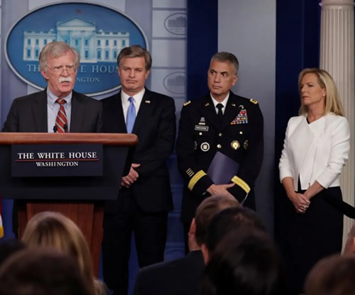 Bolton (podium) holds security briefing in White House press briefing room