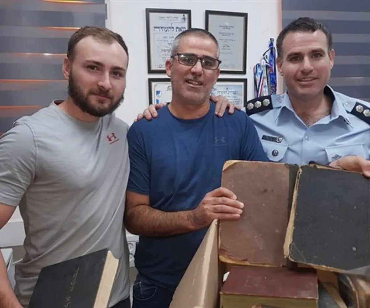Undercover officers display holy books recovered before sale