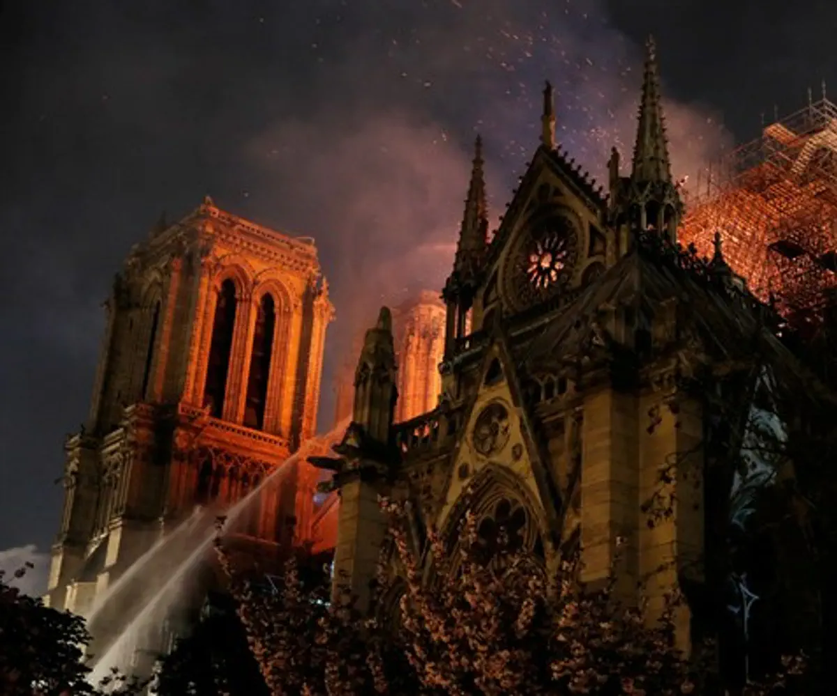 Paris Fire brigade spray water to extinguish flames as Notre Dame burns