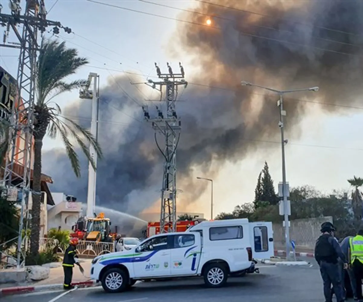 Israeli firefighters work to extinguish a fire at a factory in Sderot