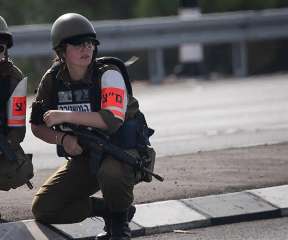 Israeli Military Police crouch for cover during Red Alert siren
