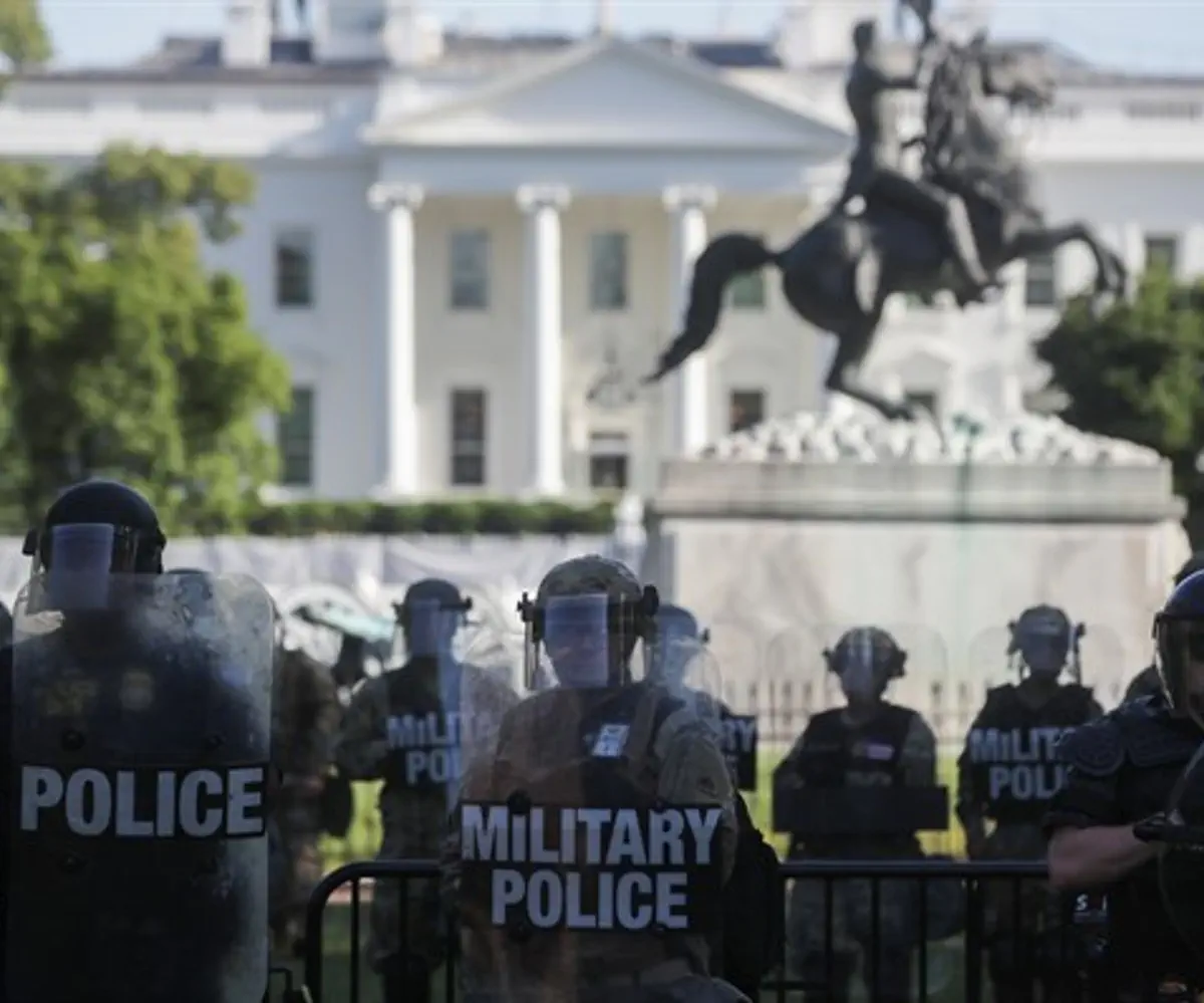 National Guard officers look on as demonstrators rally near the White House