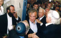 Elie Wiesel hangs a mezuzah - next to Michael Mark