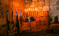Lighting Hanukkah candles at ancient synagogue in Arab town