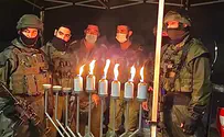 Netzach Yehuda soldiers light Hanukkah candles at attack site