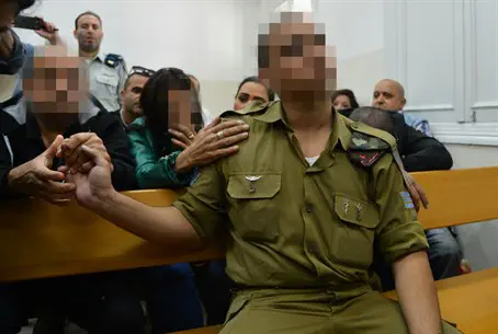 Soldier in court flanked by relatives
