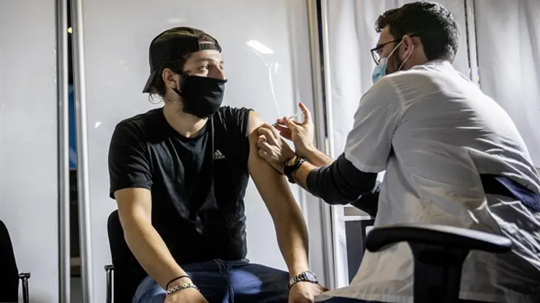 Man receives coronavirus vaccine in Jerusalem (illustrative)