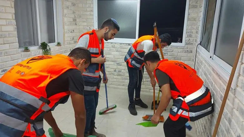 Volunteers cleaning up after rocket strike