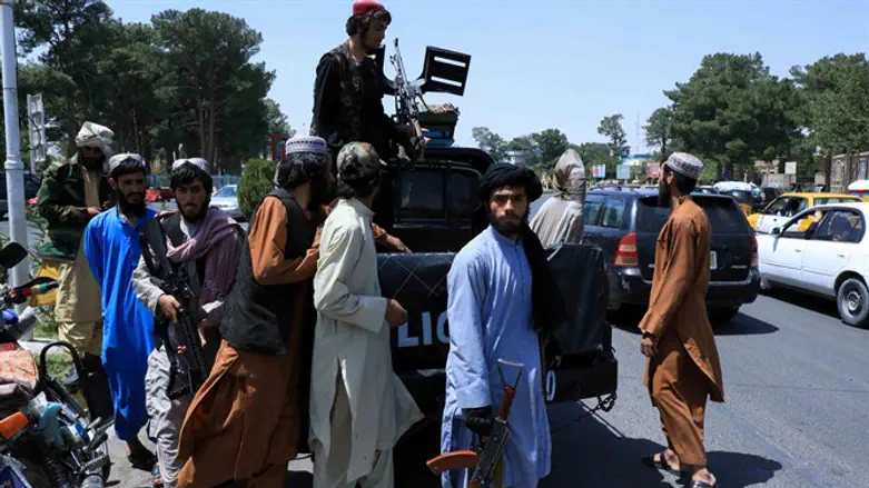 Taliban forces patrol a street in Herat, Afghanistan