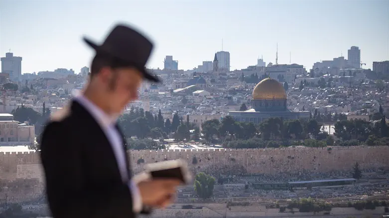 Jew prays on Mount of Olives facing Temple Mount