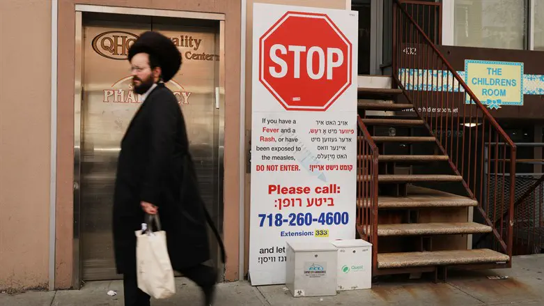 A sign warns people of measles symptoms in Williamsburg, Brooklyn in 2019.