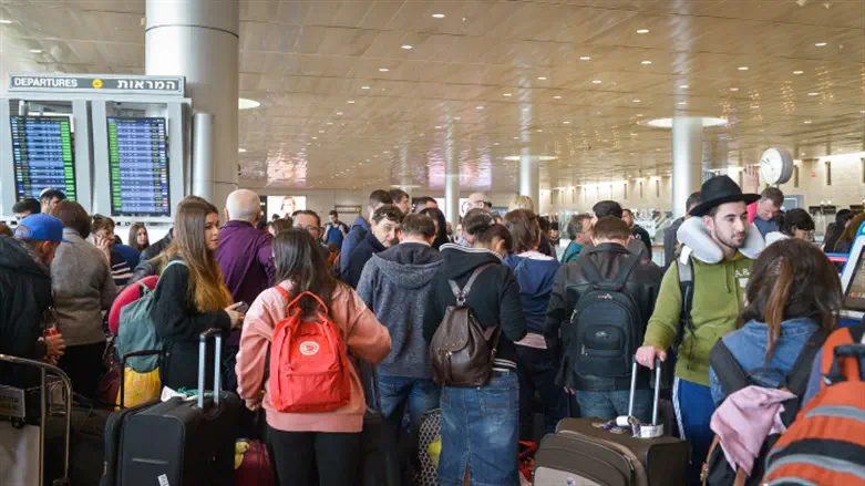 Passengers wait in line at Ben Gurion Airport