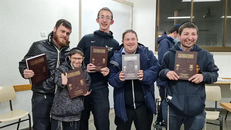 Students at Yeshivat Darkaynu receive gemaras in honor of completing a tractate.