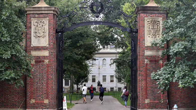 Students walk by the Harvard Yard gate in Cambridge, MA, Sep. 16, 2021.