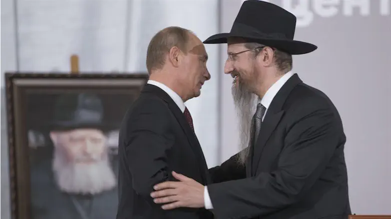 Russian President Vladimir Putin, left, is greeted by Russia’s Chief Rabbi Berel Lazar