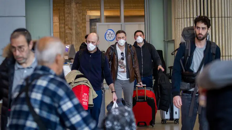 Passengers wearing masks at Ben Gurion Airport