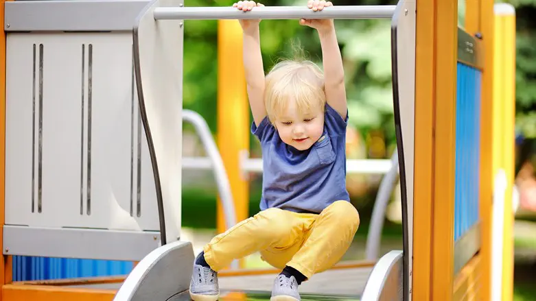 Young child on playground equipment