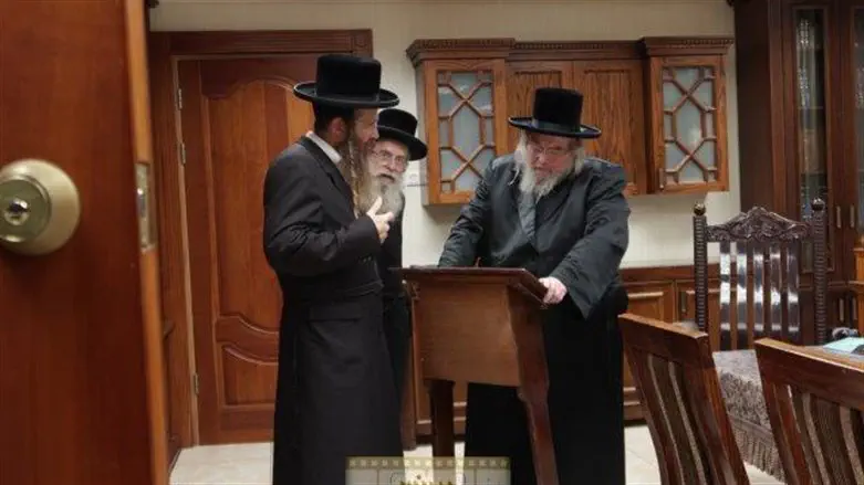 The hasid brings the historic lectern to the Belzer Rebbe