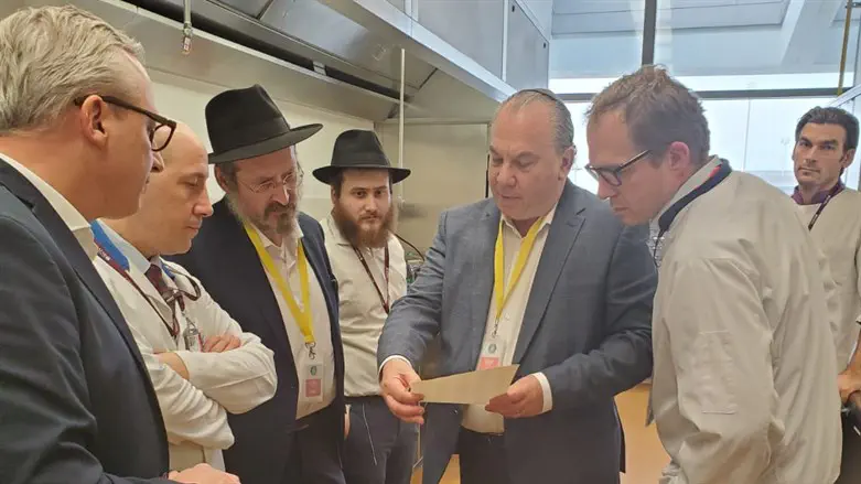 Rabbi Marc Schneier, holding paper, and Rabbi Mendy Chitrik, third from left
