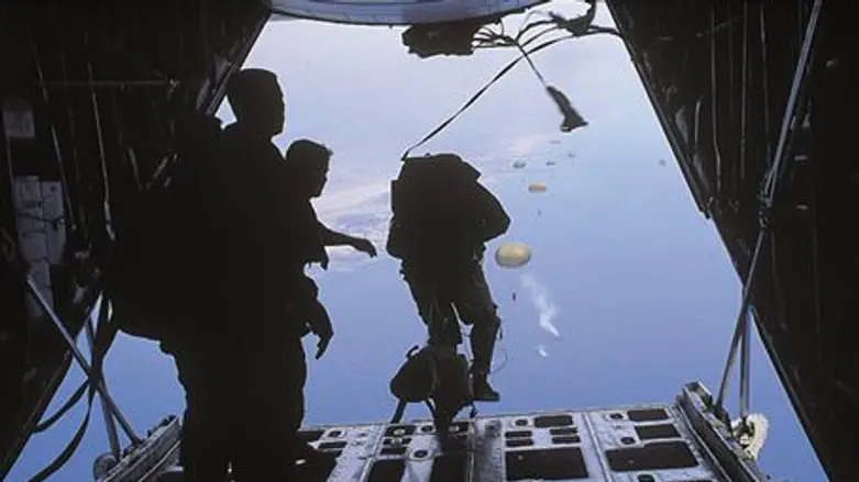 Paratroopers jump from an Israeli C-130J