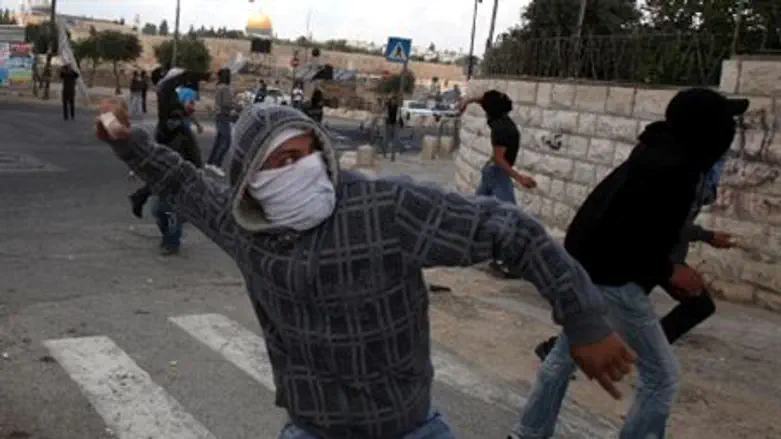 Arab Nakba Day rioter hurls rock (file) 