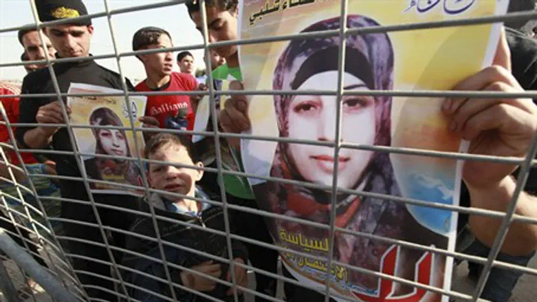 Arabs hold posters of Hana Shalbi