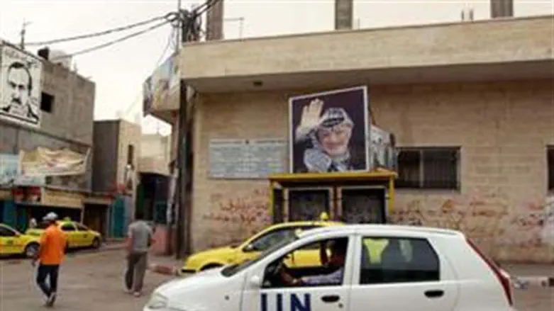 UN Car passes poster of Arafat in Bethlehem  