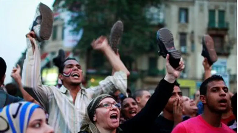 Protesters wave their shoes at Tahrir Squar