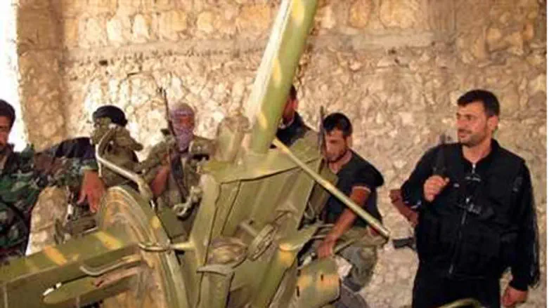 Syrian rebels inspect captured weapons 