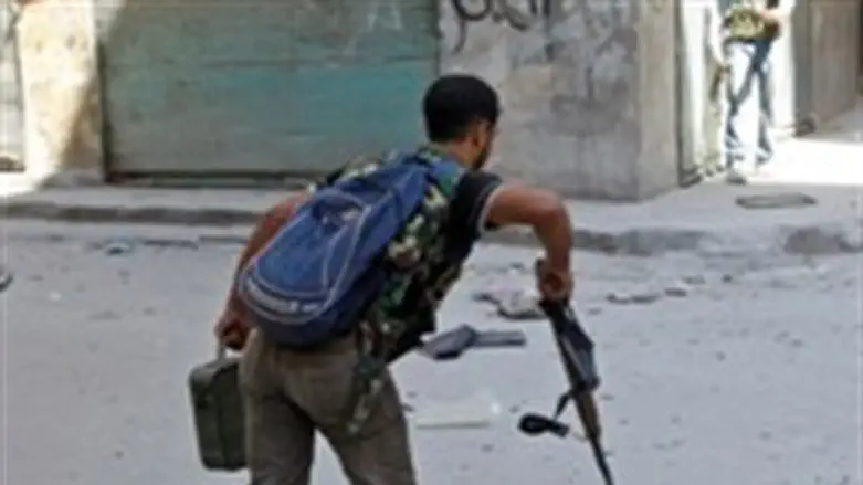  Free Syrian Army fighter runs across a stree