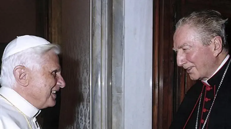 File photo of Pope Benedict XVI shaking hands