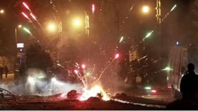 Fireworks explode as protesters clash with ri