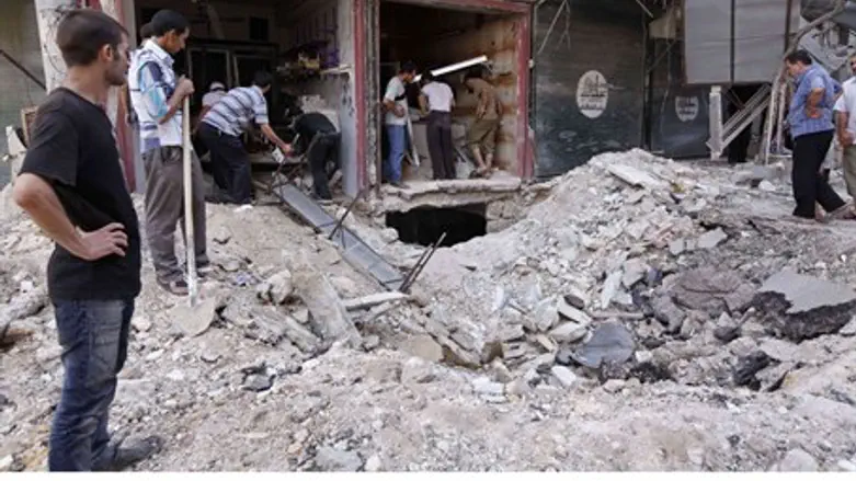 Civilians view debris from Syrian gov't air s