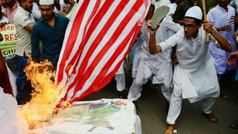 Demonstrators set fire to a mock coffin of Pr