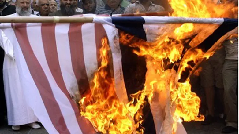 Lebanese Muslims burn a U.S. flag during a de