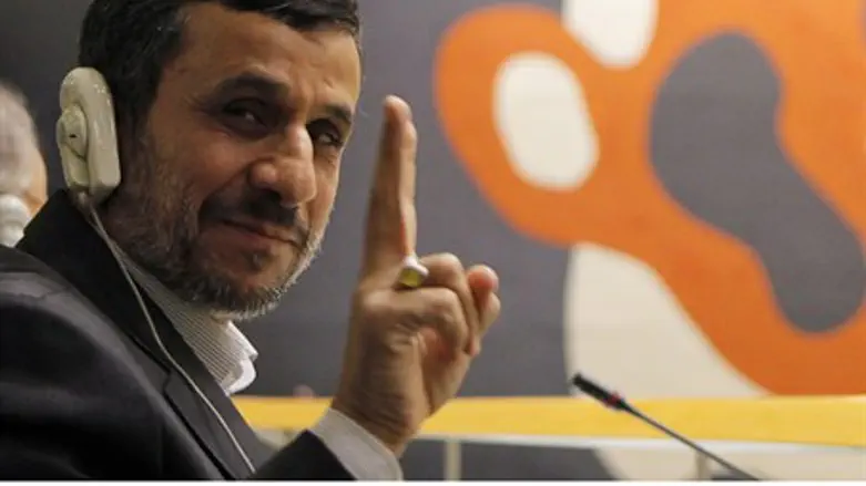 Iran's President Mahmoud Ahmadinejad flashes 