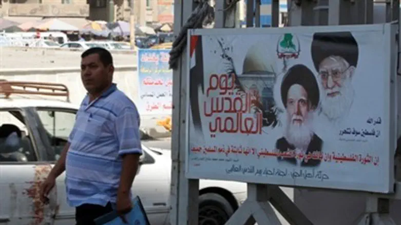 A man passes near a picture of Iranian spirit
