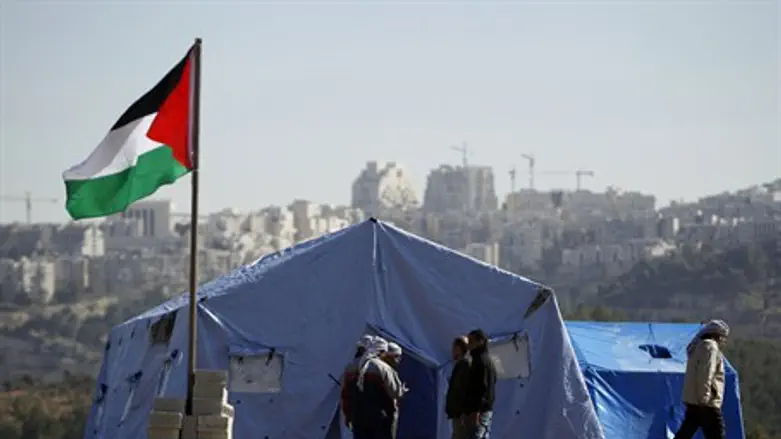 PA Arabs stand near tents in outpost in Beit 