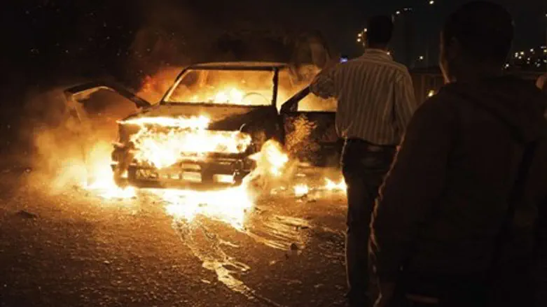 An Egyptian police car set ablaze on Cairo's 