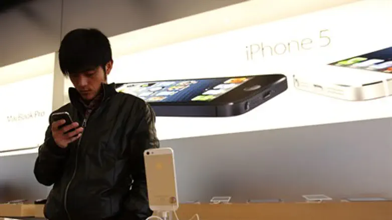 A visitor tries an iPhone at an Apple store 