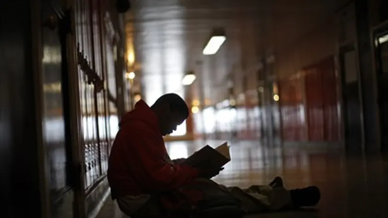 student reads book in high school