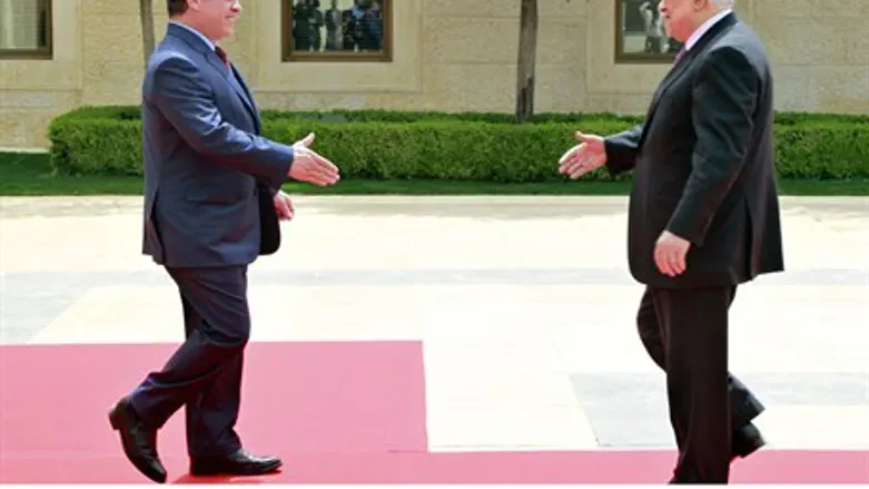 King Abdullah of Jordan, left, meets Mahmoud 