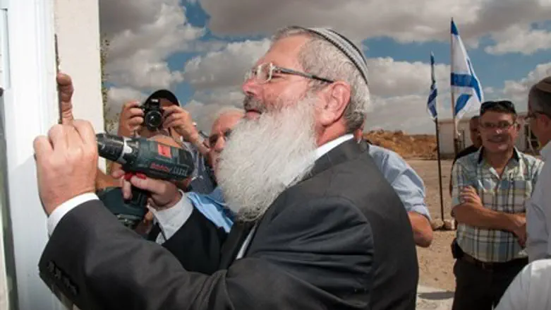 Rabbi Ben-Dahan affixes a mezuzah in Shdema