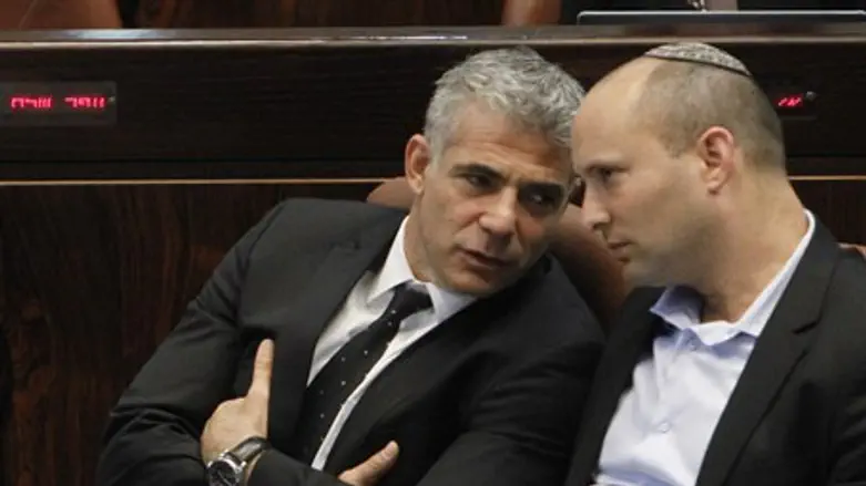 Lapid and Bennett talk during Knesset session