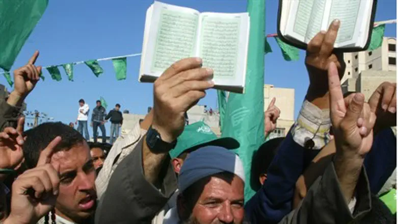 Hamas supporters hold copies of the Koran dur
