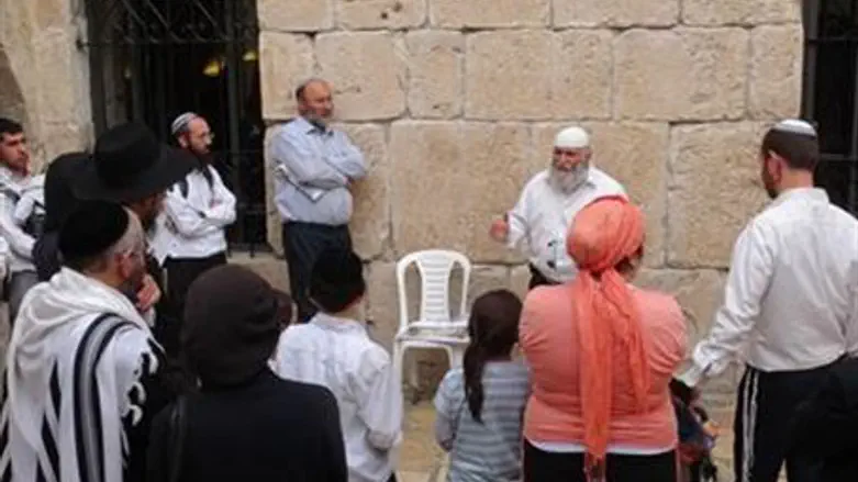 Rabbi Sevilia guides visitors to Tomb.