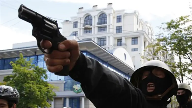 Pro-Russia 'activist' aims a pistol at pro-Ki